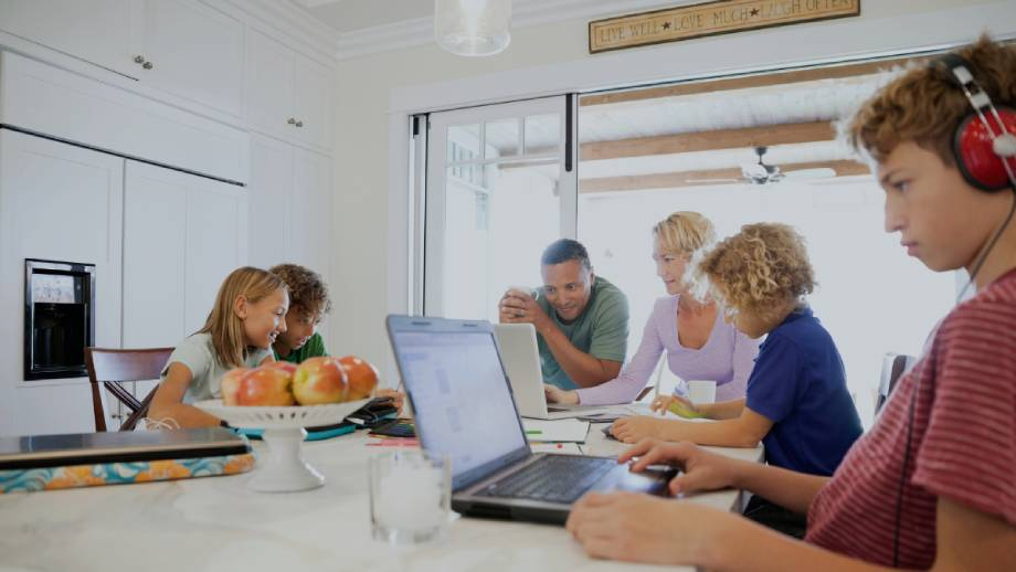 A family connected to fast uncapped home internet while using multiple devices