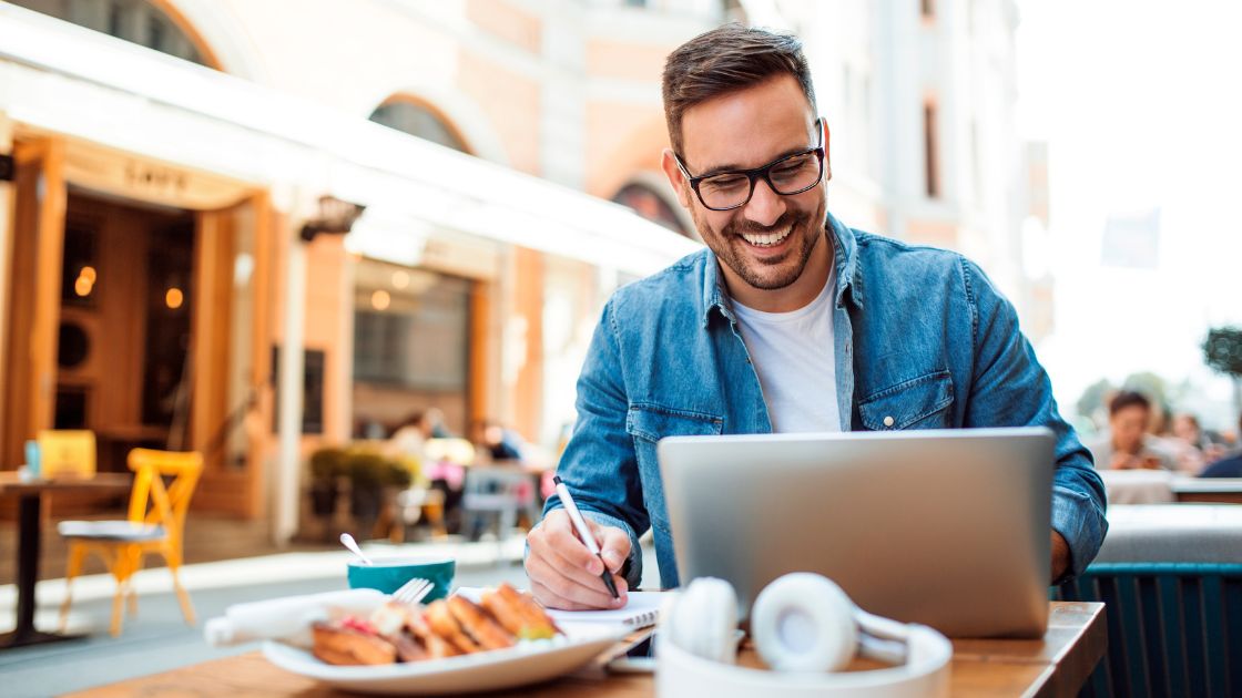 Man working on computer while making notes | #InternetProviderNearMe